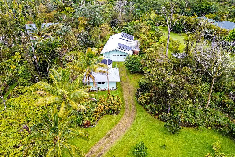 Tropical Island Retreat with Two Garages on a Landscaped Acre in Pahoa property photo